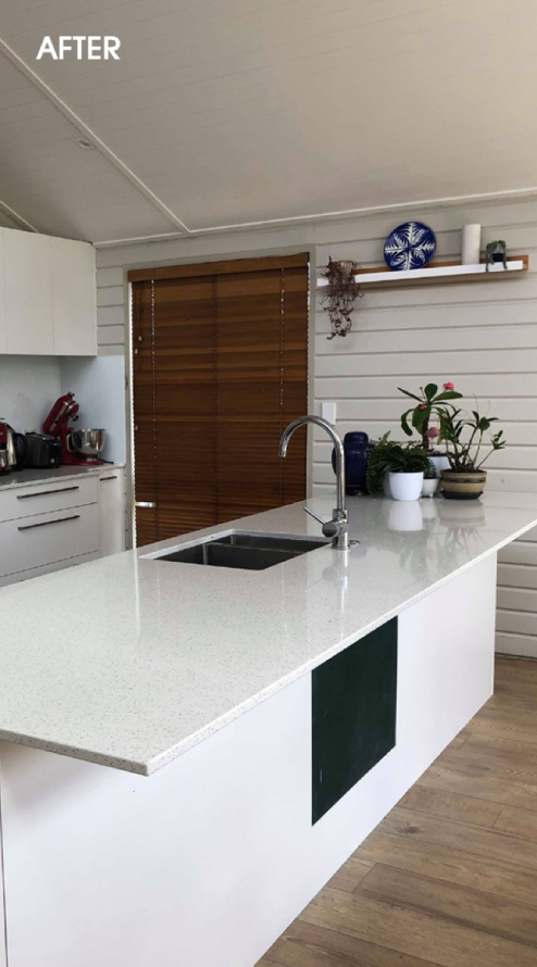 cheerful cleaner standing near cart with cleaning supplies and smiling at camera